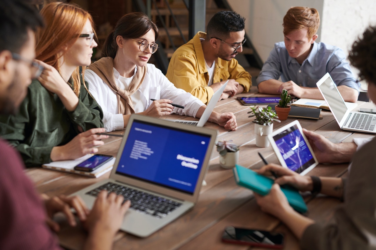 Employees with technical skills looking at a presentation on their devices